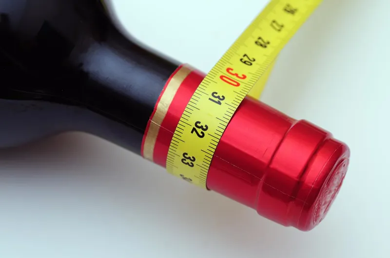 Wine bottle with tape measure around it