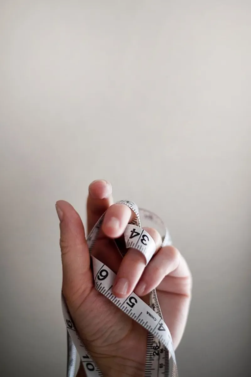 Hand holding a tape measure