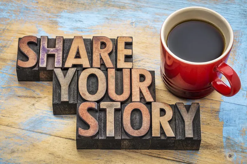 Share your story spelled in letterpress blocks beside a mug of coffee