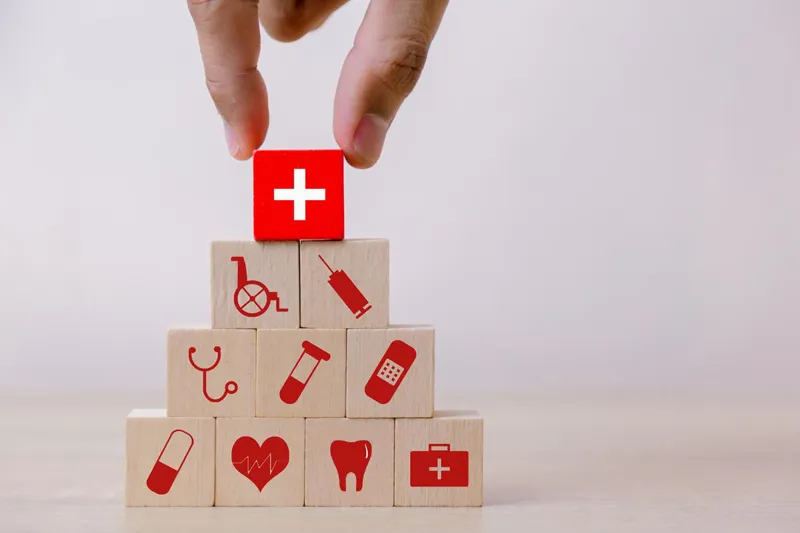 Wooden blocks with health icons stacked in a pyramid