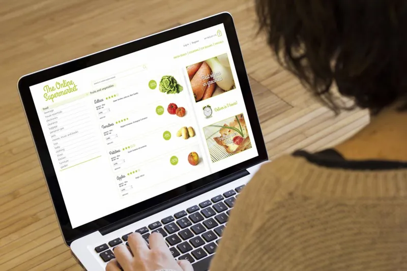 Person browsing an online supermarket on a laptop