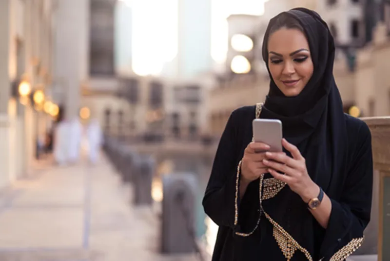 Woman in a headscarf using her mobile phone