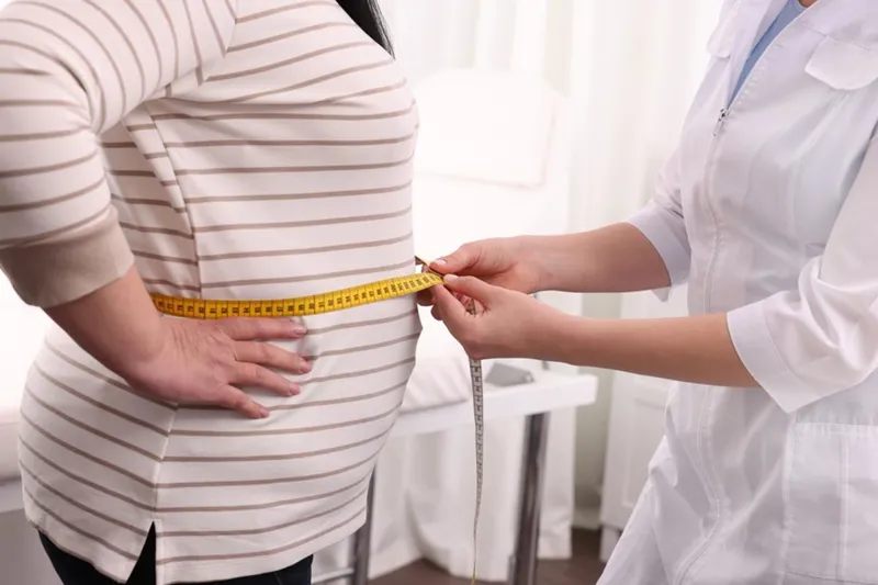 Person being measured with a tape measure