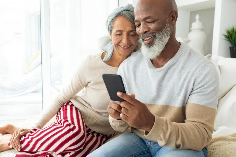 Two people sharing a smartphone screen