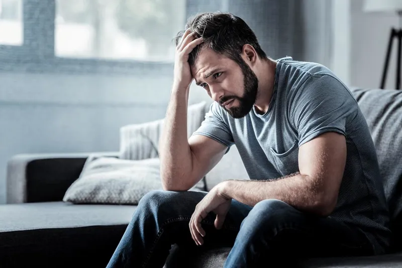 Person sitting alone looking down