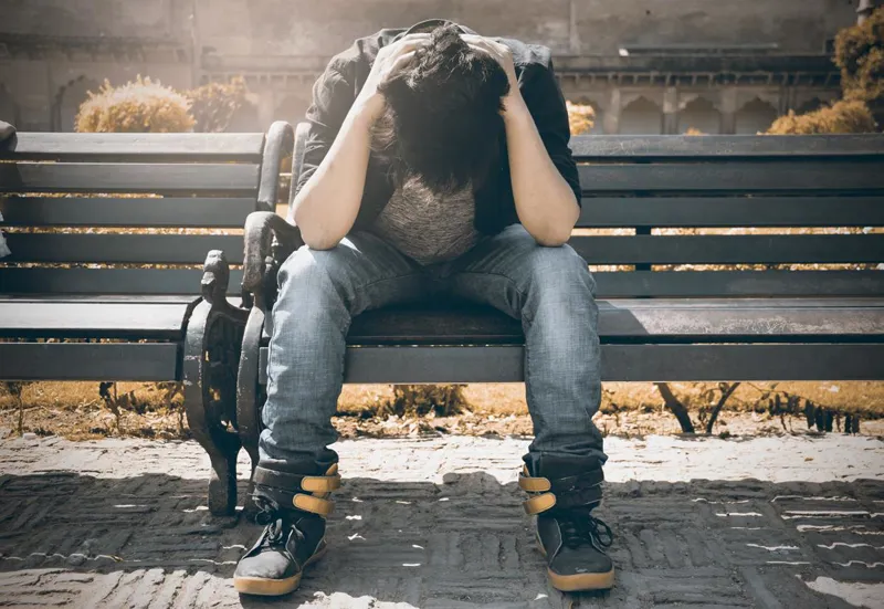 Someone sitting alone on a bench