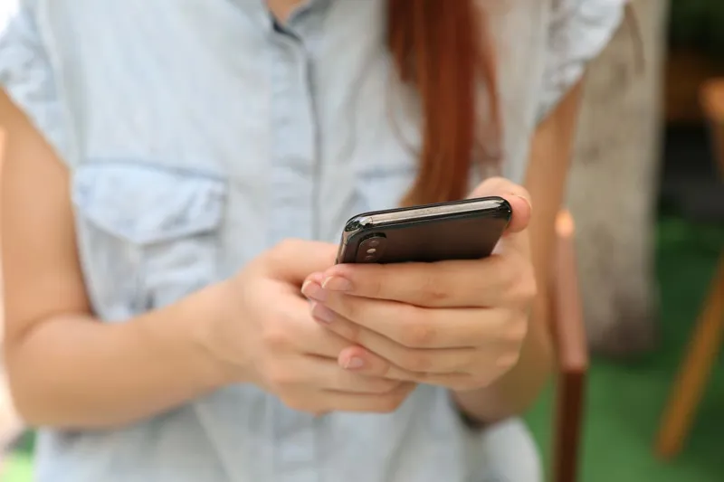 Woman holding a smartphone in both hands