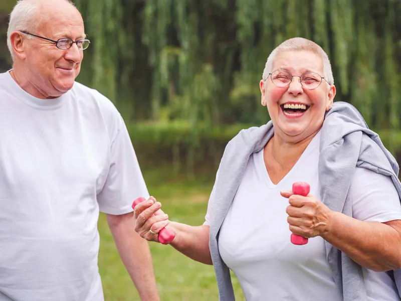 Older man and woman exercising outdoors