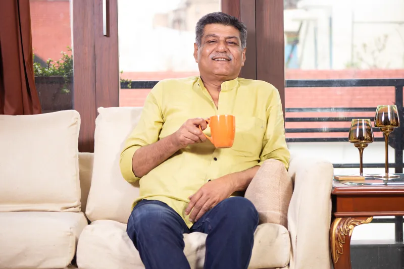 senior-man-having-coffee-at-home-and-relaxing-looking-at-the-camera (old site media 3209)