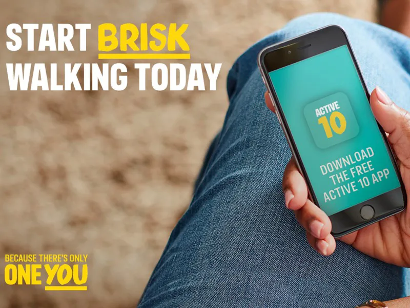 Leg with phone held in front of it. Start brisk walking today