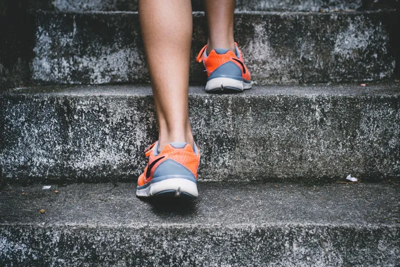 Prevention - Runner climbing outdoor steps