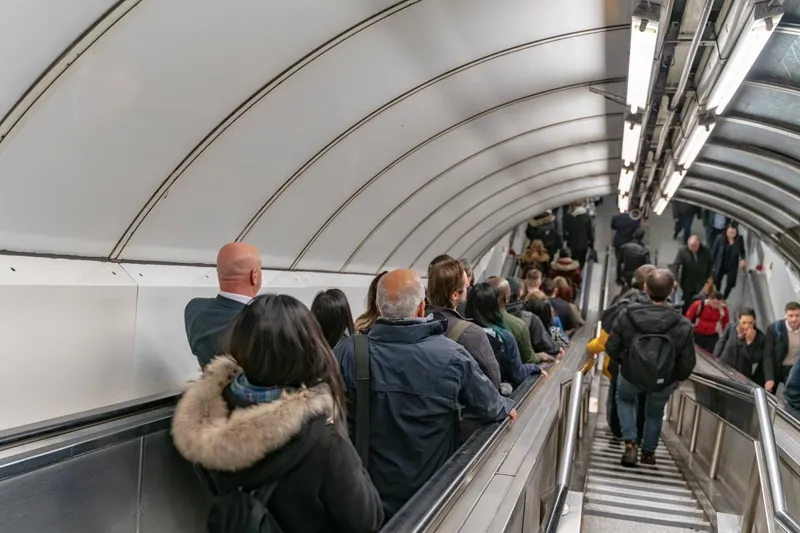 People on an escalator and some on stairs